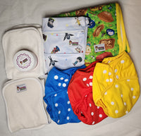 Blue, Yellow, and Red one size cloth diaper cover bundle including inserrts, changing pad, wetbag, and diaper cream.