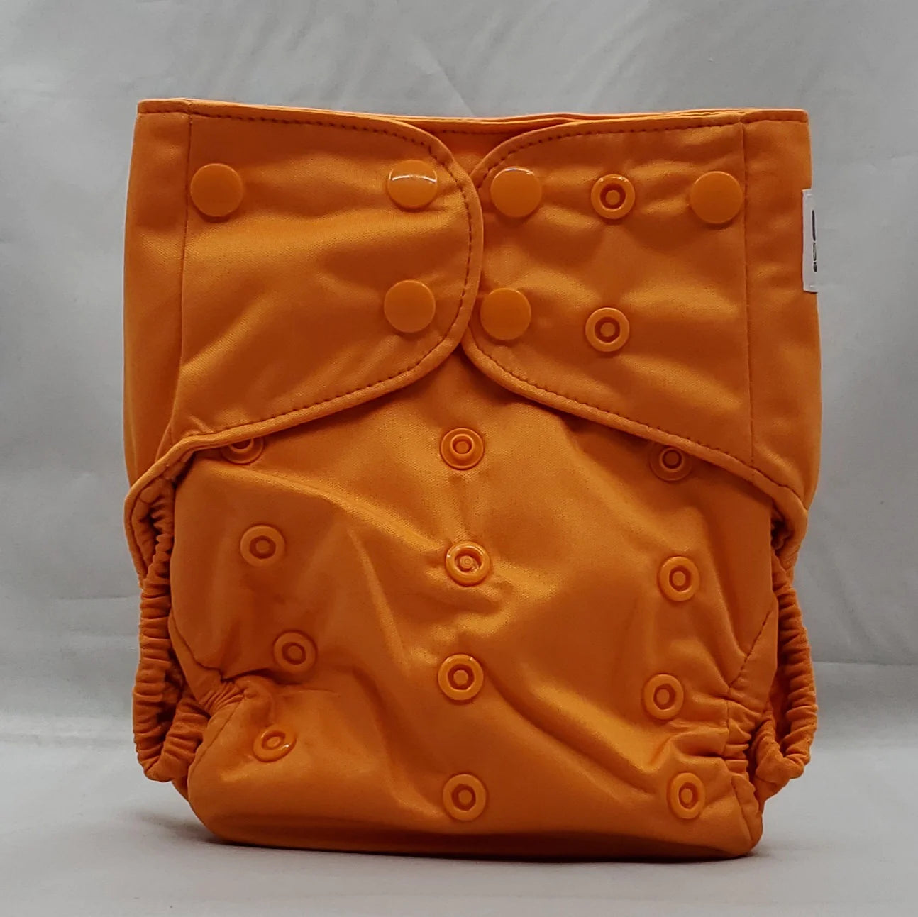 overnight cloth diaper. A modern cloth diaper with a fandom-inspired design. Vibrant and detailed, color inspired by legend of zelda. Ganon Orange