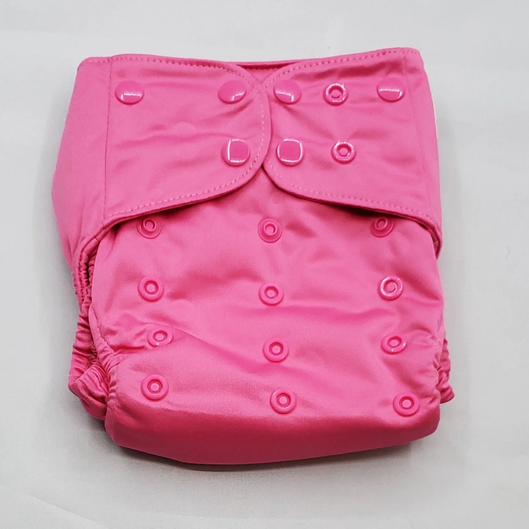 overnight cloth diaper. A modern cloth diaper with a fandom-inspired design. Vibrant and detailed, color inspired by legend of zelda, princess zelda pink