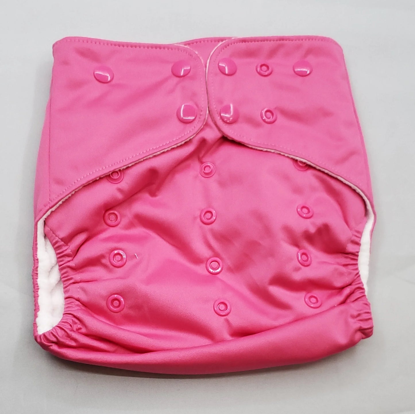 A modern cloth diaper with a fandom-inspired design. Vibrant and detailed, color is inspired by Legend of Zelda, Princess Zelda Pink