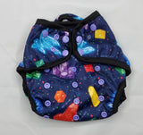 A modern cloth diaper with a fandom-inspired design. Vibrant and detailed, it showcases polyhedral dice, roleplaying classes, and healing crystals. waterproof cover